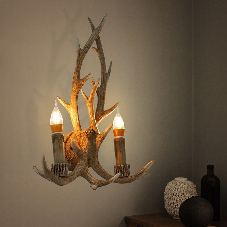 a deer antler with three candles on it