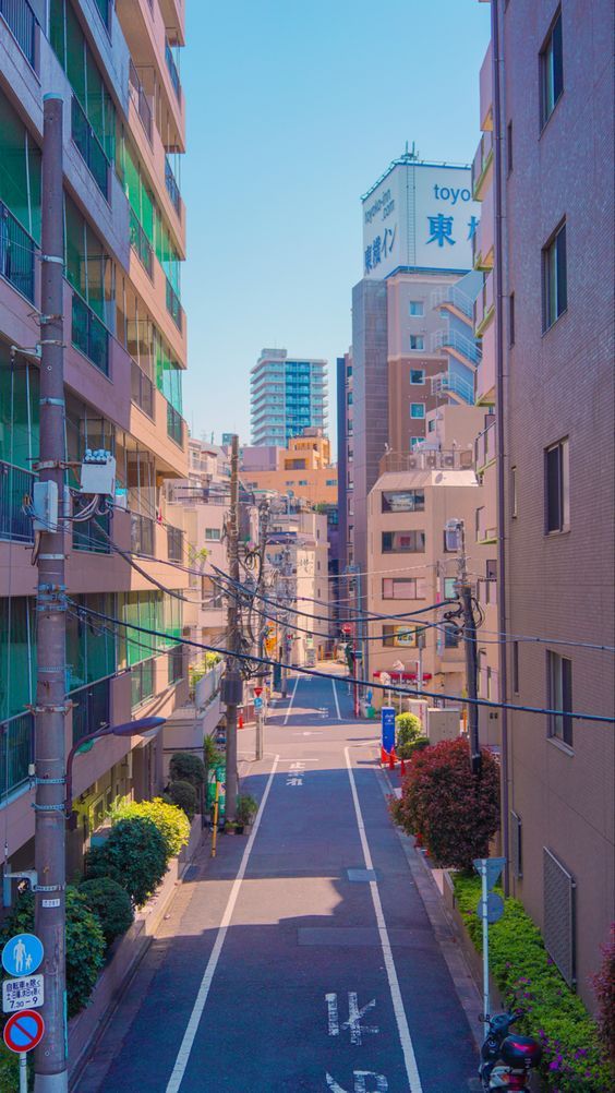 an empty city street lined with tall buildings