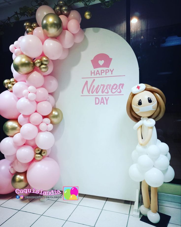 the balloon arch is decorated with pink, white and gold balloons for nurse's day