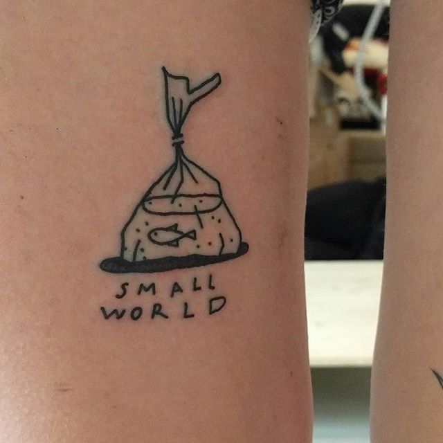 two people with tattoos on their legs that say small world and smile at each other