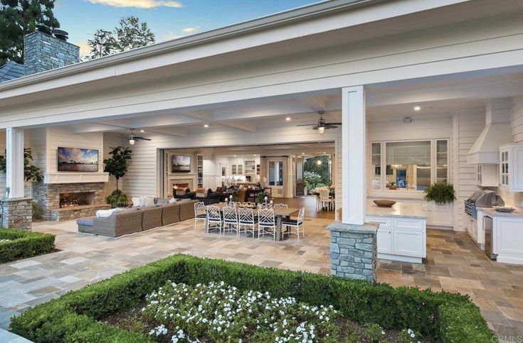 an outdoor living room and dining area are shown