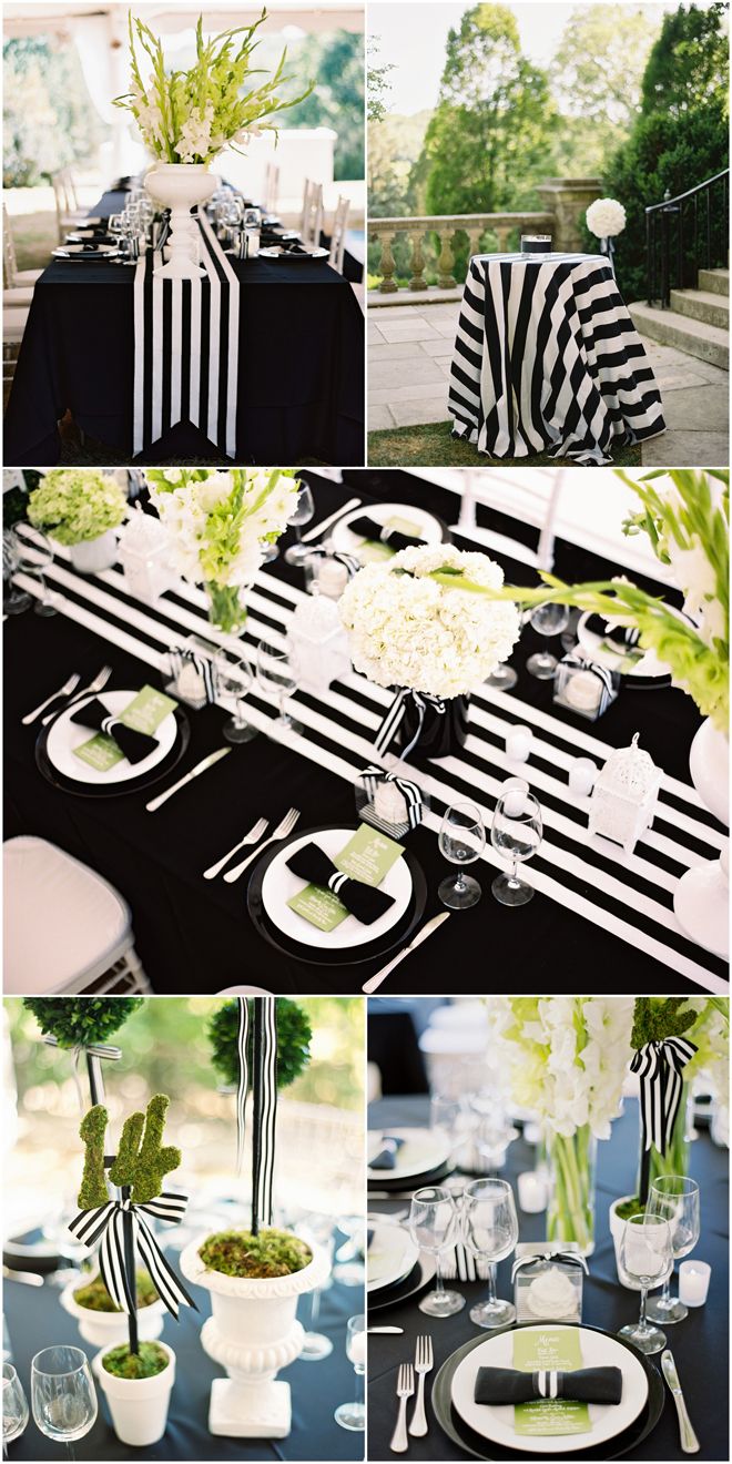 black and white table setting with flowers in vases, striped napkins, silverware