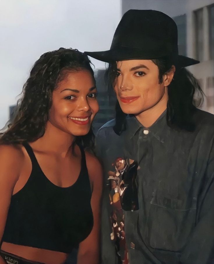 a man in a cowboy hat standing next to a woman