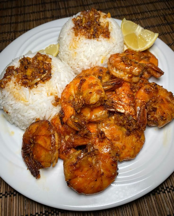 a white plate topped with rice and shrimp