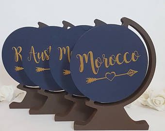 three wooden coasters with gold lettering on them