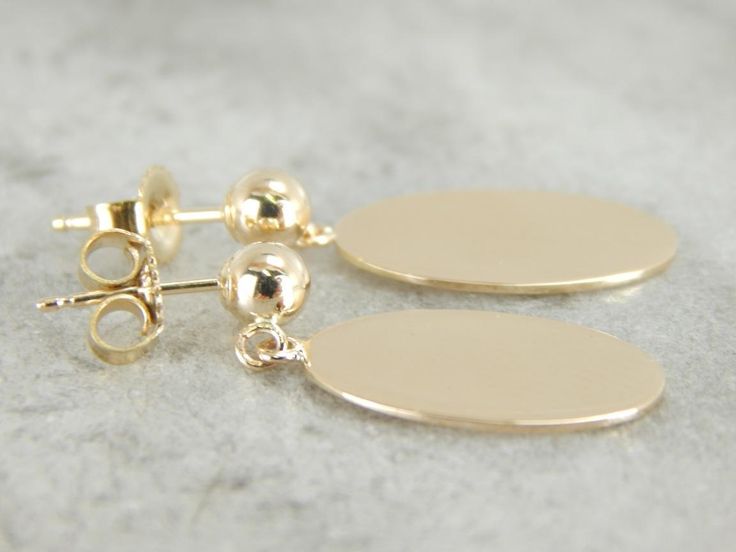 Beautifully polished and simple as can be in design. These gleaming yellow gold drops were adapted from a pair of antique cufflinks, and hung from simple stud earrings. Metal: 14K Yellow Gold Earrings Length: 22 mm Earring Width: 9 mm Marks: "14K" Stamped on the findings Oblong Yellow Gold Earrings For Gift, Minimalist Oval Link Earrings For Formal Occasions, Yellow Gold Oblong Earrings For Gift, Elegant Tarnish Resistant Oblong Earrings, Formal Oval Link Earrings With Polished Finish, 14k Gold Oblong Earrings For Gift, Formal Oval Link Polished Earrings, 14k Gold Oblong Earrings As Gift, Elegant Tarnish-resistant Oblong Earrings