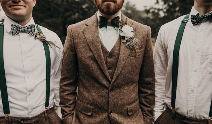 three men wearing bow ties and vests standing next to each other