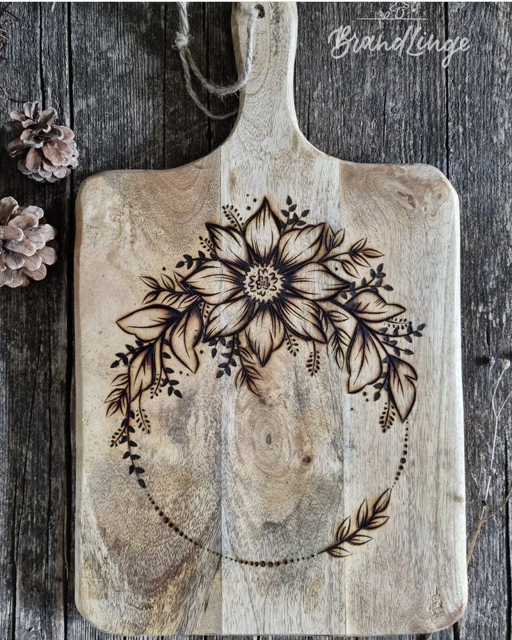 a wooden cutting board with flowers on it