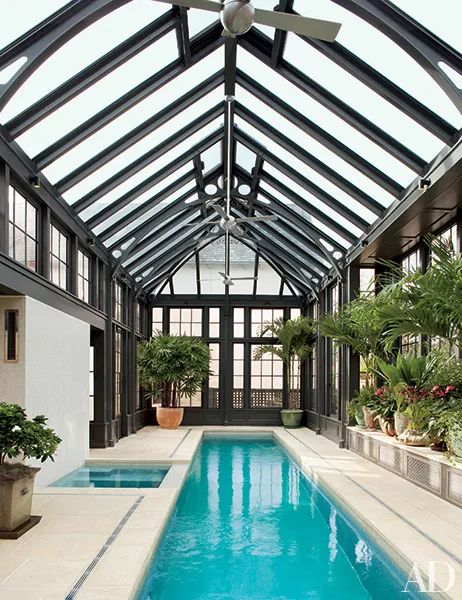 an indoor swimming pool in the middle of a house