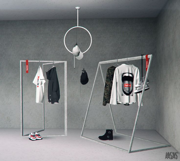 an empty room with clothes and shoes hanging from the ceiling, next to a pair of boots