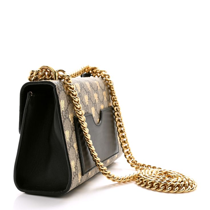 This is an authentic GUCCI GG Supreme Monogram Bees Small Padlock Shoulder Bag in Black. This stylish tote is crafted of brown on beige Gucci GG monogram coated canvas accented with gold bee silhouettes. The bag features a gold chain shoulder strap and a large press lock on the front. The flap opens to a beige fabric interior with a patch pocket. Bee Silhouette, Gg Monogram, Gold Bee, Beige Fabric, Shoulder Bag Black, Gold Chain, Patch Pocket, Gold Chains, Shoulder Strap