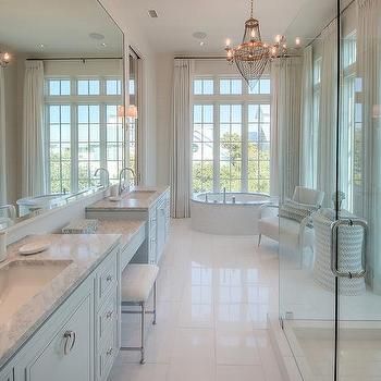 a large bathroom with double sinks and mirrors