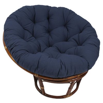 a round chair with purple cushions on it