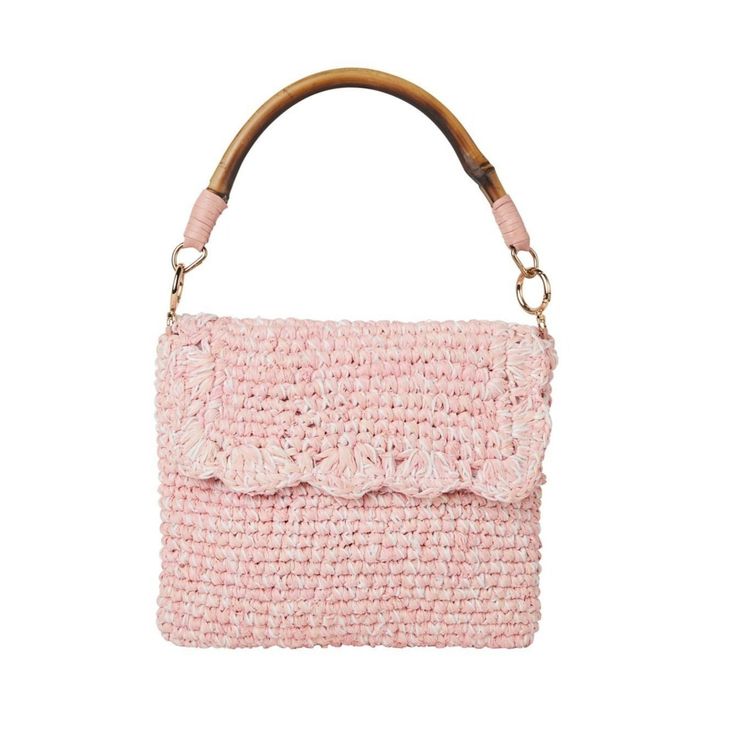 a pink handbag on a white background with a wooden handle and two small pieces of fabric