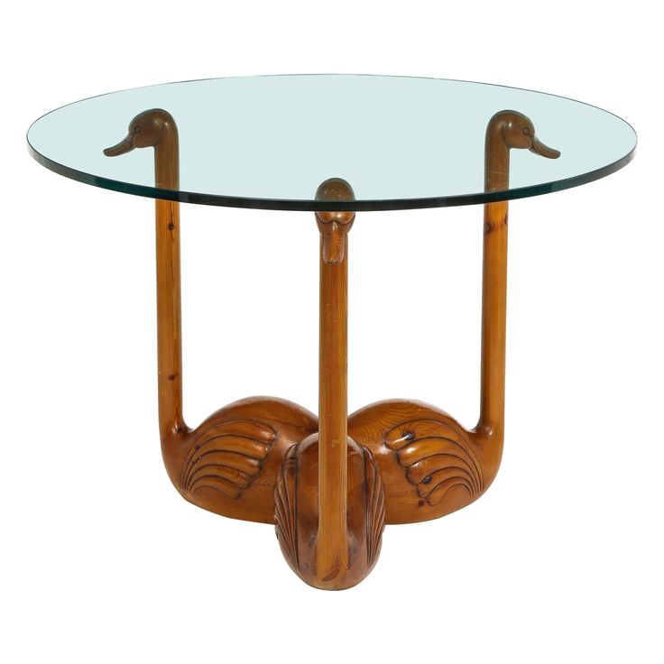 a glass and wood table with two birds on the top, one bird is upside down