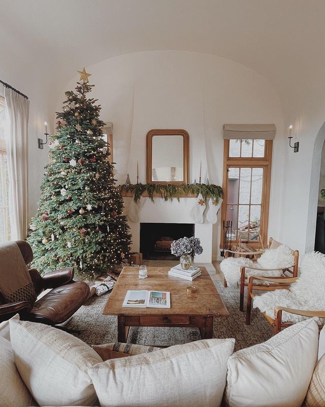 a living room filled with furniture and a christmas tree in the middle of the room