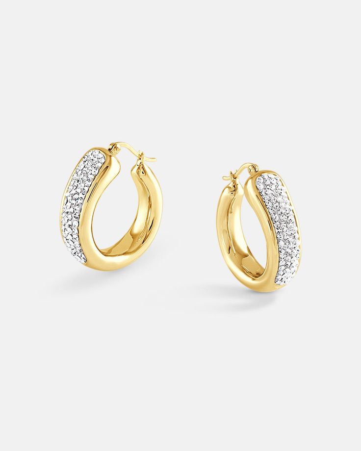 A chunky statement hoop earrings that is set with over 200 crystals. The crystals utilize our crystal luster setting technique which will make the lusters on the crystals simply pop with exuberant shine. The earrings have a rounded organic shape which give it a clean and sleek look. The earrings are made in 18K gold plated over sterling silver metal. There are 2 colors, yellow gold and white gold, to chose from. The plating color on your earrings has an effect on the tone of your skin. Give your Bamboo Hoop Earrings, Treasure Jewelry, Cheap Earrings, Statement Hoop Earrings, Chunky Hoop Earrings, Crystal Hoop Earrings, Silver Shop, Earring Sale, Ear Jewelry