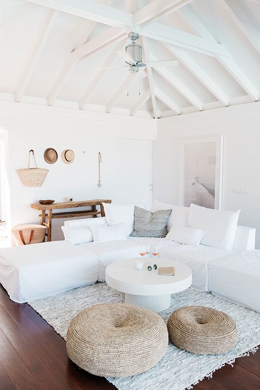 a white couch sitting on top of a wooden floor