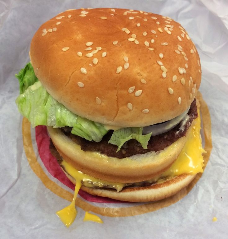 a hamburger with lettuce and cheese on it