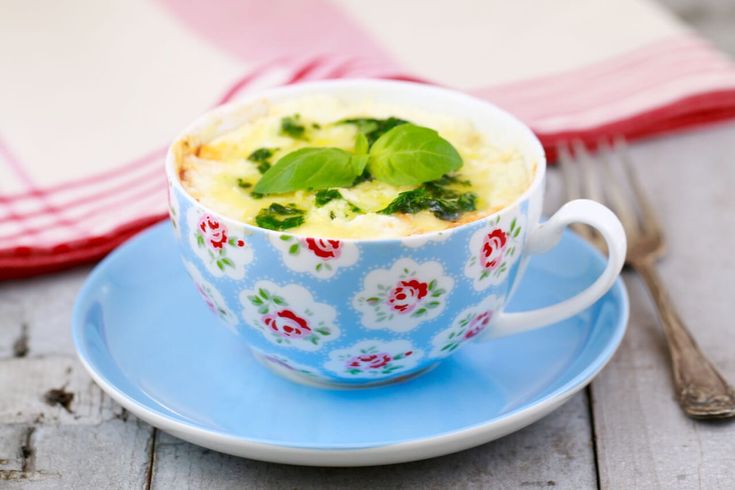 a blue and white cup filled with food on top of a plate