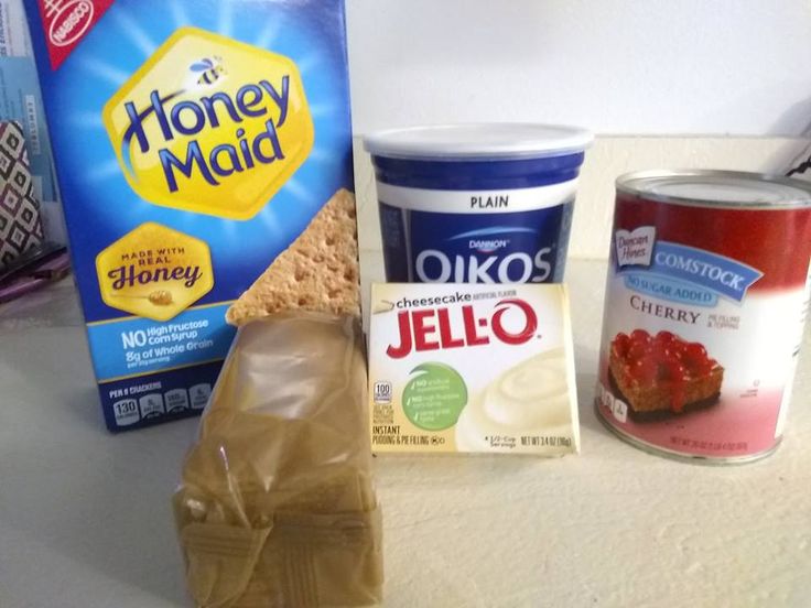 some food items are sitting on a counter next to a box of yogurt