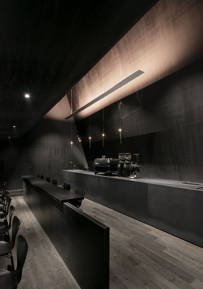 an empty conference room with black walls and chairs