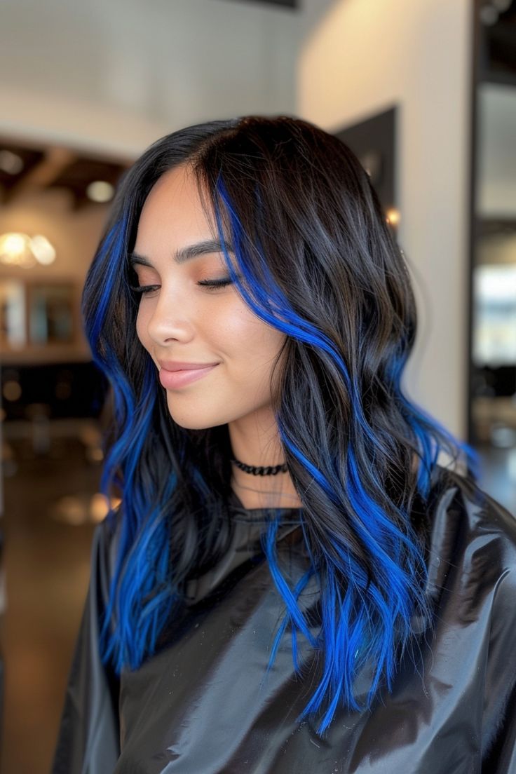 Woman smiling with long black hair and vibrant blue highlights. Brown To Blue Ombre Hair, Blue Hair Peekaboo, Black To Blue Hair, Blue Hair Balayage, Blue And Brown Hair, Highlight Hairstyles, Black Ombre Hair, Hair Peekaboo, Blue Hair Streaks