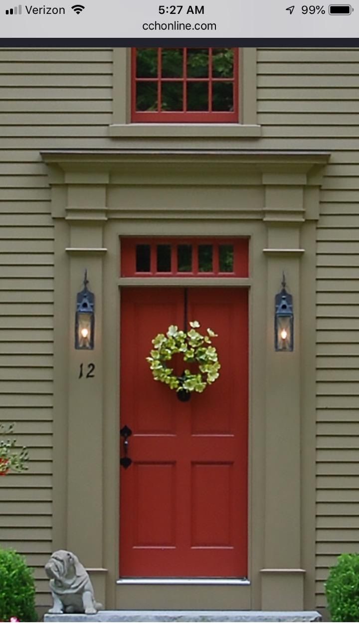 a red front door with a wreath on it