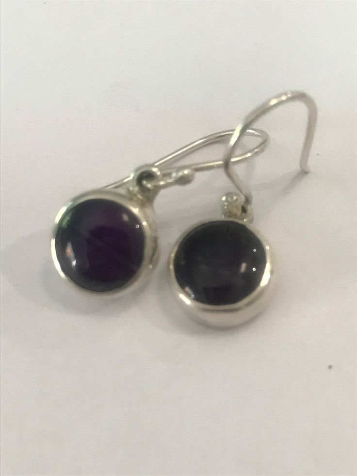 .925 Mexican Silver and Black Amethyst earrings. 1cm round, french hook findings. Statement silver Sterling Silver Round Earrings With Lever Back, Silver Round Pendant Earrings For Formal Events, Silver Round Pendant Earrings For Formal Occasions, Classic Purple Drop Earrings, Classic Sterling Silver Purple Earrings, Classic Purple Sterling Silver Earrings, Black Amethyst Round Jewelry, Hallmarked Sterling Silver Round Earrings, Sterling Silver Round Hallmarked Earrings