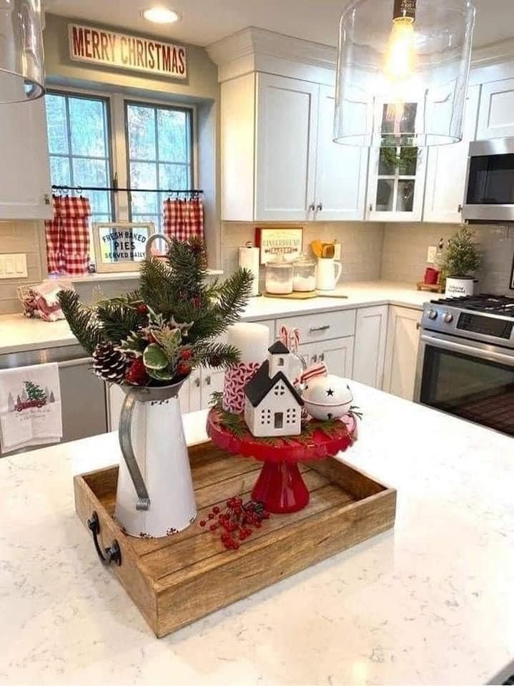 a kitchen decorated for christmas with ornaments on the counter and in front of the stove