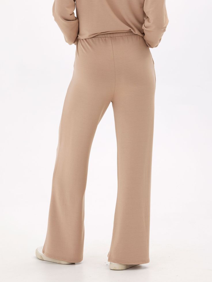 Elevate your loungewear game with our Angela Modal Terry Wide Leg Pants! Made with a buttery soft material and featuring a thick stretchy waistband, these pants offer both comfort and style. The wide leg design adds a touch of elegance to your casual look. Don't settle for ordinary loungewear, treat yourself to our elevated piece. Solid Color Sweatpants With Elastic Waistband For Relaxation, Comfy Lounge Bottoms In Solid Color, Comfortable Solid Color Lounge Pants, Versatile Full-length Loungewear Pants, Versatile Loungewear Pants, Chic Yoga Pants With Elastic Waistband, Chic Full-length Sweatpants With Elastic Waistband, Long Yoga Pants With Elastic Waistband For Loungewear, Solid Sweatpants With Elastic Waistband For Lounging