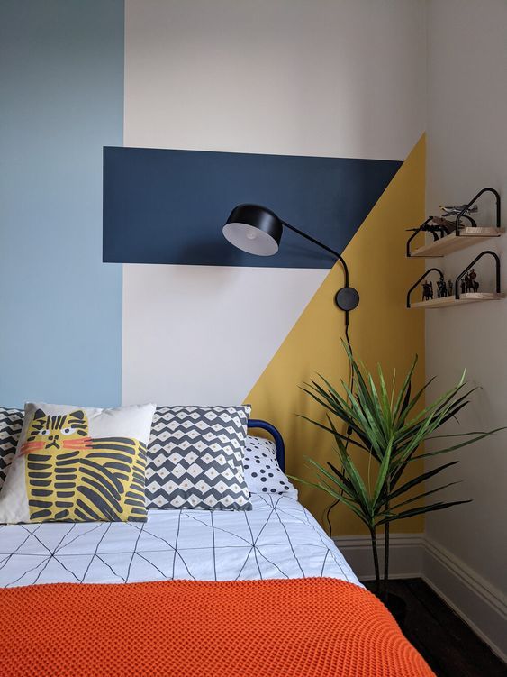 a bed room with a neatly made bed and a potted plant