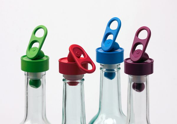 three empty glass bottles with scissors in them