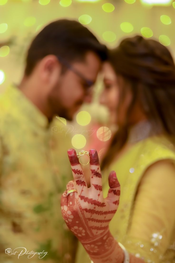 a man and woman standing next to each other holding their hands up in the air