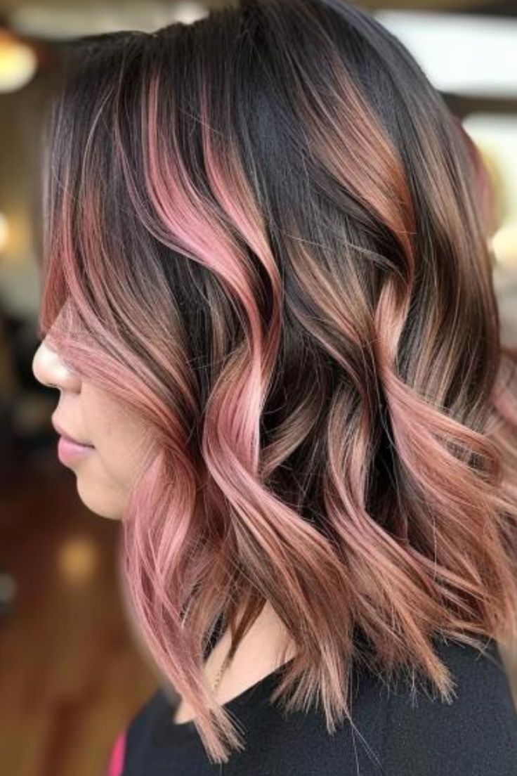 Rose gold touches add a trendy, romantic flair to your hair. This unique color blends pink and gold tones, creating a warm, glowing effect. Click here to check out more best partial highlights to transform your hair. Pastel Highlights In Brown Hair, Pale Pink Highlights In Brown Hair, Short Rose Gold Hair, Rose Gold Highlights Brunette, Hair Color Inspiration For Brunettes, Rose Gold Balayage Brunettes, Pink Highlights In Brown Hair, Brown Hair With Pink Highlights, Autumn Hair Color