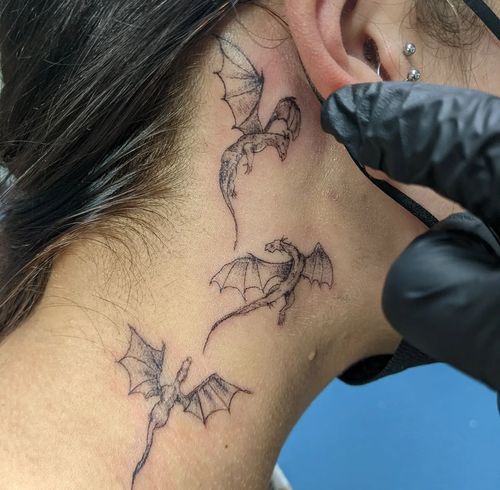 a woman with a bat tattoo on her neck