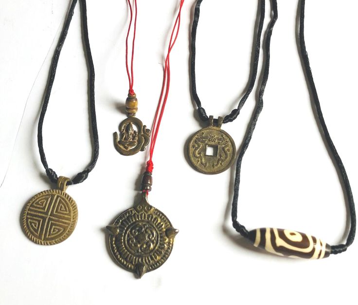 These pendants symbolize for healing and protections. They are old and used for health, wealth and protections from everything. Made out of bronze most of them. (1) Tibetan dzi design pendant (2) Mandala for protect from four directions pendant (3) Good luck and Fortune pendant (4) Feng shui for good luck and power. This pendant has design on both sides. feng shui symbols for good luck and dragon for power. (5) Ganesh in the Om letter. Protections, health and wealth. Traditional Medallion Necklace For Good Luck, Traditional Good Luck Medallion Necklace, Bronze Spiritual Jewelry For Good Luck, Amulet Style Long Necklace For Meditation, Symbolic Bronze Necklace For Meditation, Blessing Amulet Necklace With Coin Pendant, Bronze Amulet Necklace For Rituals, Bronze Amulet Necklace For Blessing, Bronze Good Luck Amulet Necklace