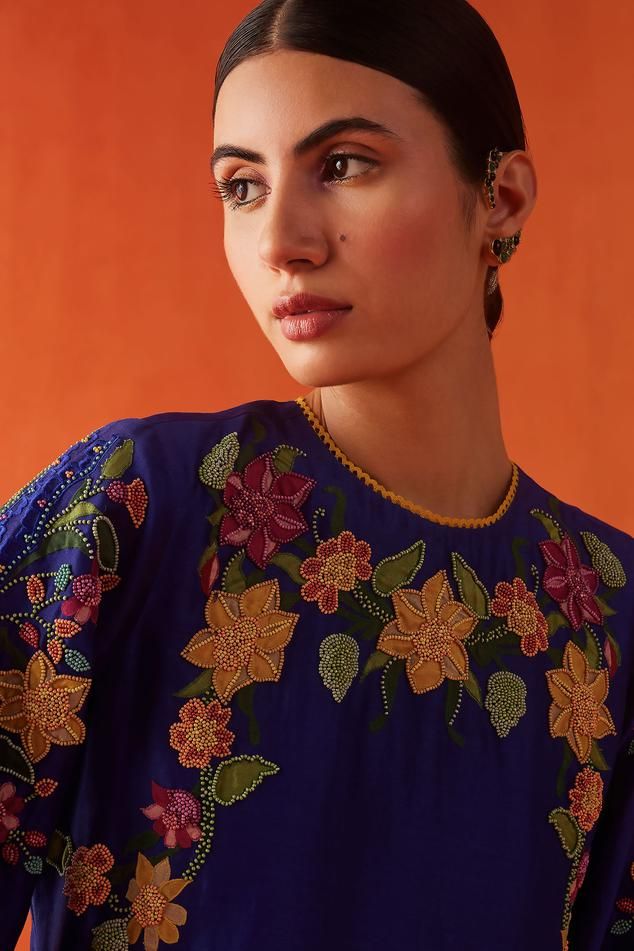 Cobalt blue chanderi kurta with multi-colored beads and floral applique embroidery. Comes with pant.
Components: 2
Pattern: Applique embroidered
Type Of Work: Beads, Floral
Neckline: Round
Sleeve Type: Flared Sleeves
Fabric: Chanderi, Lining : 100% Cotton
Color: Blue
Other Details: 
Attached lining
Model Height : 5 ft 6 inches, wearing size S
Occasion: Sangeet - Aza Fashions Blue Silk Kurta With Dori Work, Bohemian Blue Set With Floral Embroidery, Bohemian Blue Sets With Floral Embroidery, Transitional Blue Salwar Kameez With Floral Embroidery, Blue Straight Kurta With Floral Embroidery, Blue Floral Embroidered Straight Kurta, Blue Bohemian Kurta With Dupatta, Blue Floral Embroidered Kurta For Reception, Blue Floral Embroidery Kurta For Reception