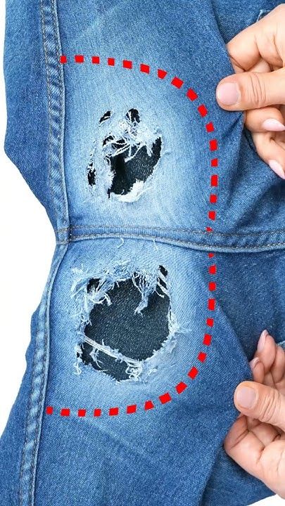 someone is holding their jeans with holes in it and pointing to the hole on the bottom