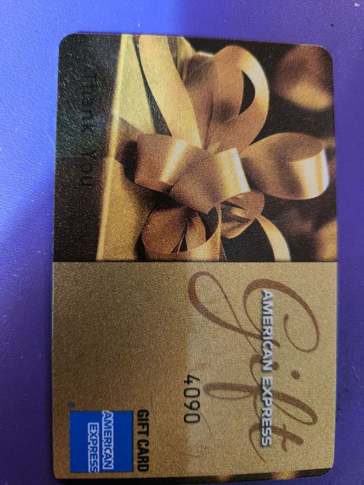 a gold credit card with a bow on it