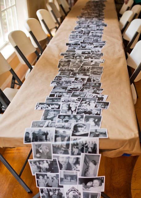 a long table topped with pictures and chairs