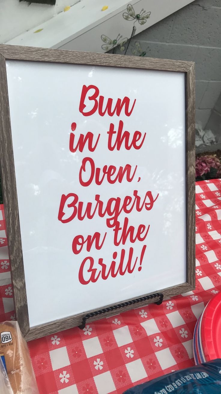 a sign that says bun in the oven burgers on the grill