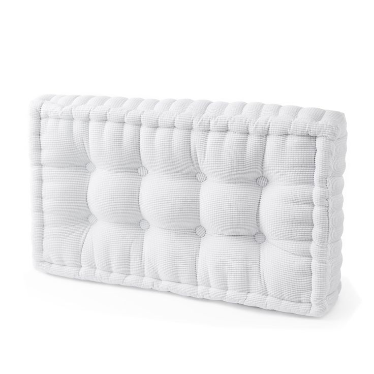 the back side of a white mattress with buttons on it's head and sides