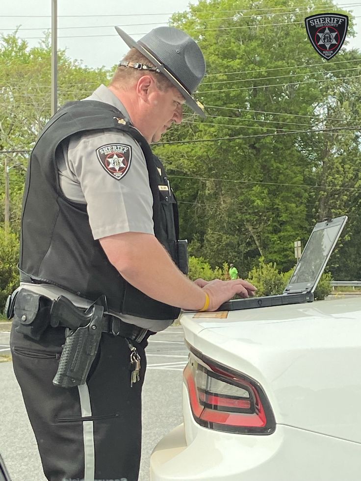 a police officer is using his laptop computer