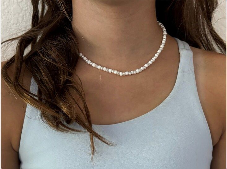 Our homemade necklace comes with white seed beads and white purls. Perfect for fancy occasions and dances! Very aesthetic and can be worn at any time of year! White Pearl Chain Choker Necklace, White Tiny Beads Pearl Choker Necklace, White Pearl Beaded Necklaces With Tiny Beads, Handmade White Pearl Choker Necklace, White Pearl Choker With Tiny Beads, Adjustable White Pearl Necklace With Round Beads, White Pearl Choker Necklace With Tiny Beads, Handmade White Pearl Choker, White Tiny Beads Choker