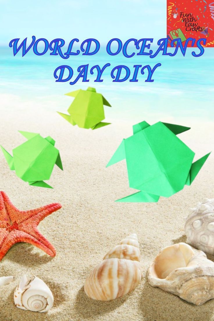 the words world oceans day are written in blue, green and orange paper on sand with sea shells