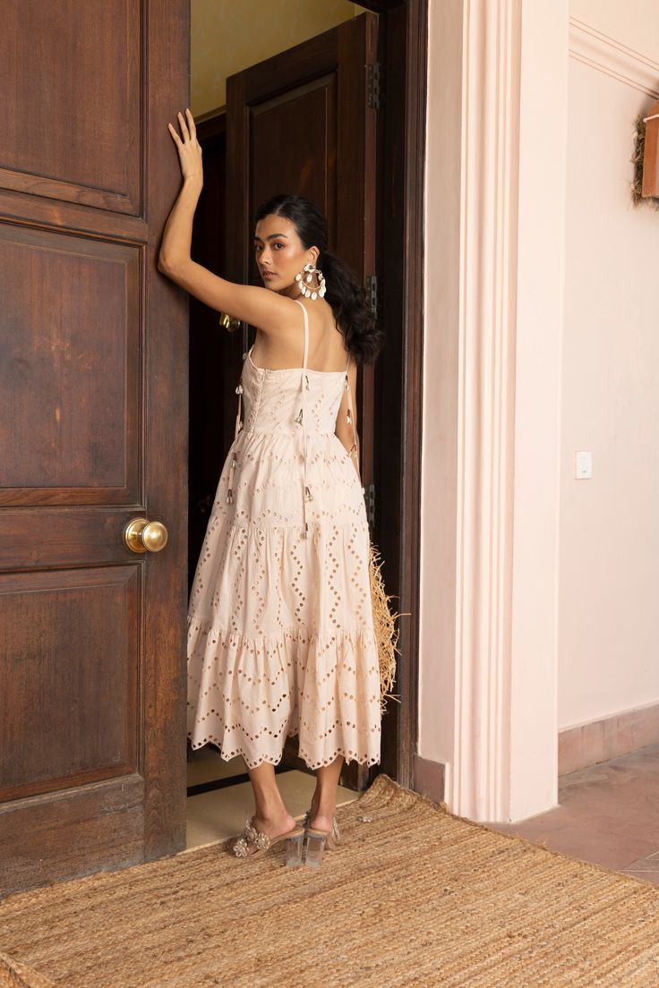 Embroidery galore- yes, please! The Frankie is a tiered dress embellished with cowrie shells and scalloped to perfection. Dress her down or up, she will be on repeat for you this entire season, we promise. The model is wearing size S. 🌸 〰️〰️〰️ 🌸 〰️〰️〰️ 🌸 Care and Composition100% Cotton.Dry clean/Hand wash in cold water. Mild liquid detergent only. Do not soak or wring. Designed & Made in India. Cowrie Shells, Liquid Detergent, Cowrie Shell, Clean Hands, Yes Please, On Repeat, Tiered Dress, Hand Washing, Cold Water