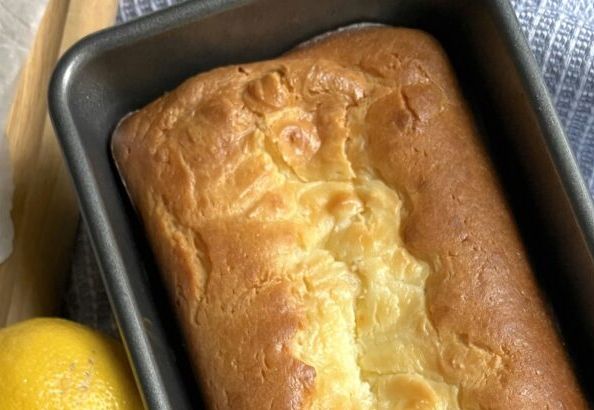 a loaf of bread in a pan next to lemons