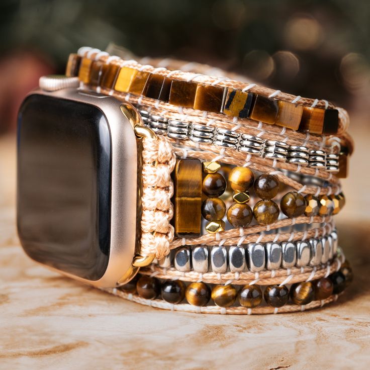 Adding a touch of elegance and nature to your Apple Watch, this Treehut watch strap features semiprecious tiger eye stones, a stone that exudes an air of mystery and romance, and metal accents with stunning golden-brown hues and mesmerizing chatoyancy. The stone's silky smooth texture and intricate patterns create a sense of depth and movement, like a glimpse into a hidden world of magic and enchantment. *Strap only; Apple Watch not included. Please check the back of your Apple Watch to make sur Marble Watch, Watch Engraving, Bracelet Apple Watch, Wooden Watch, Metal Accents, Tiger Eye Stone, Apple Watch Band, Intricate Patterns, Apple Watch Series