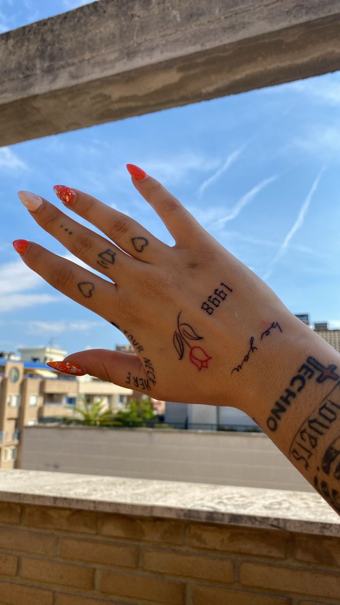 a woman's hand with tattoos on it